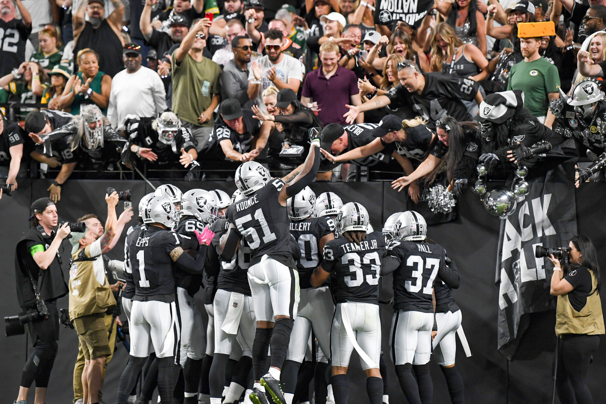 Players from the Las Vegas Raiders celebrate with their fans inside Allegiant Stadium.